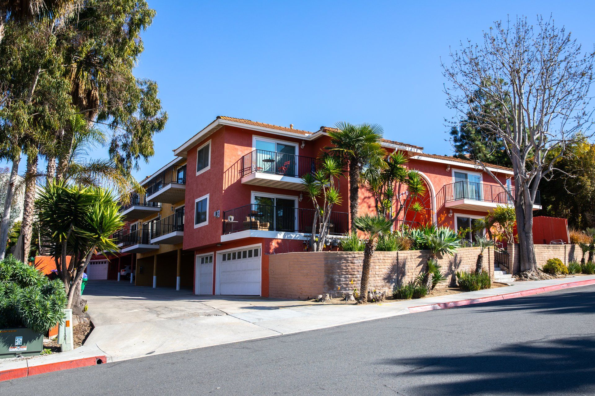 A red apartment building with a white garage door