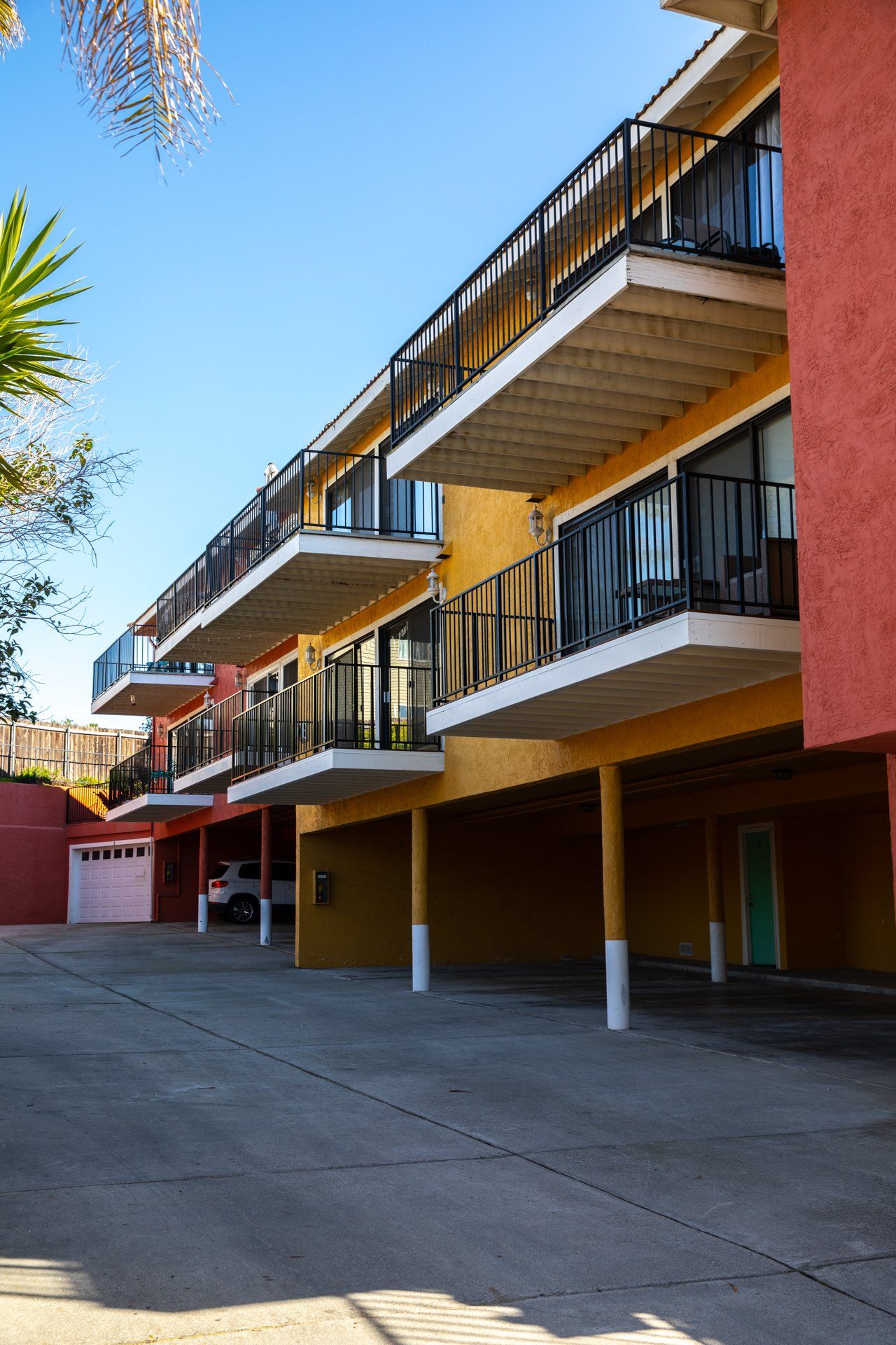 A row of apartment buildings with balconies and a garage
