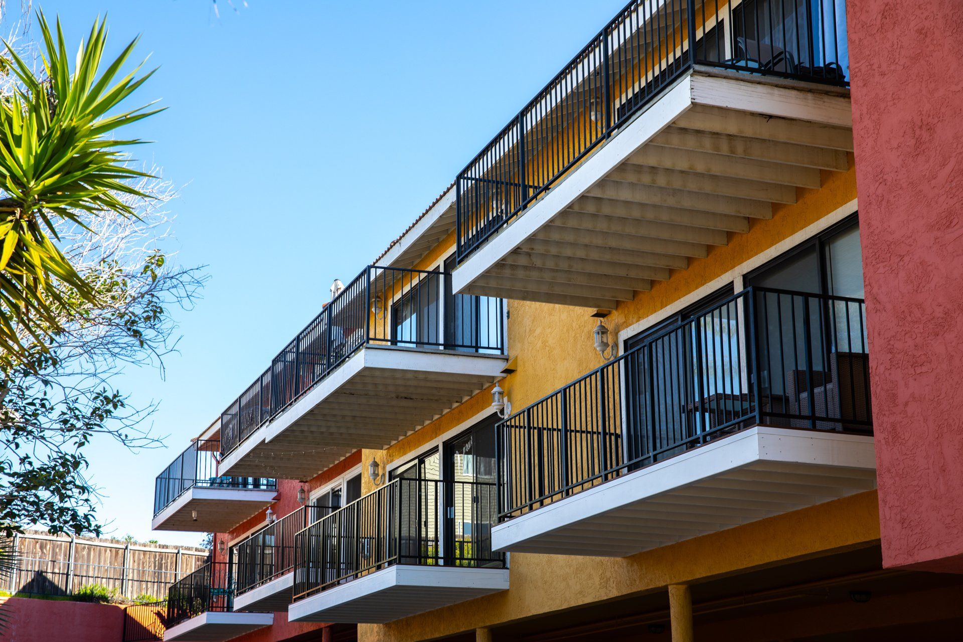 A row of apartment buildings with balconies on a sunny day