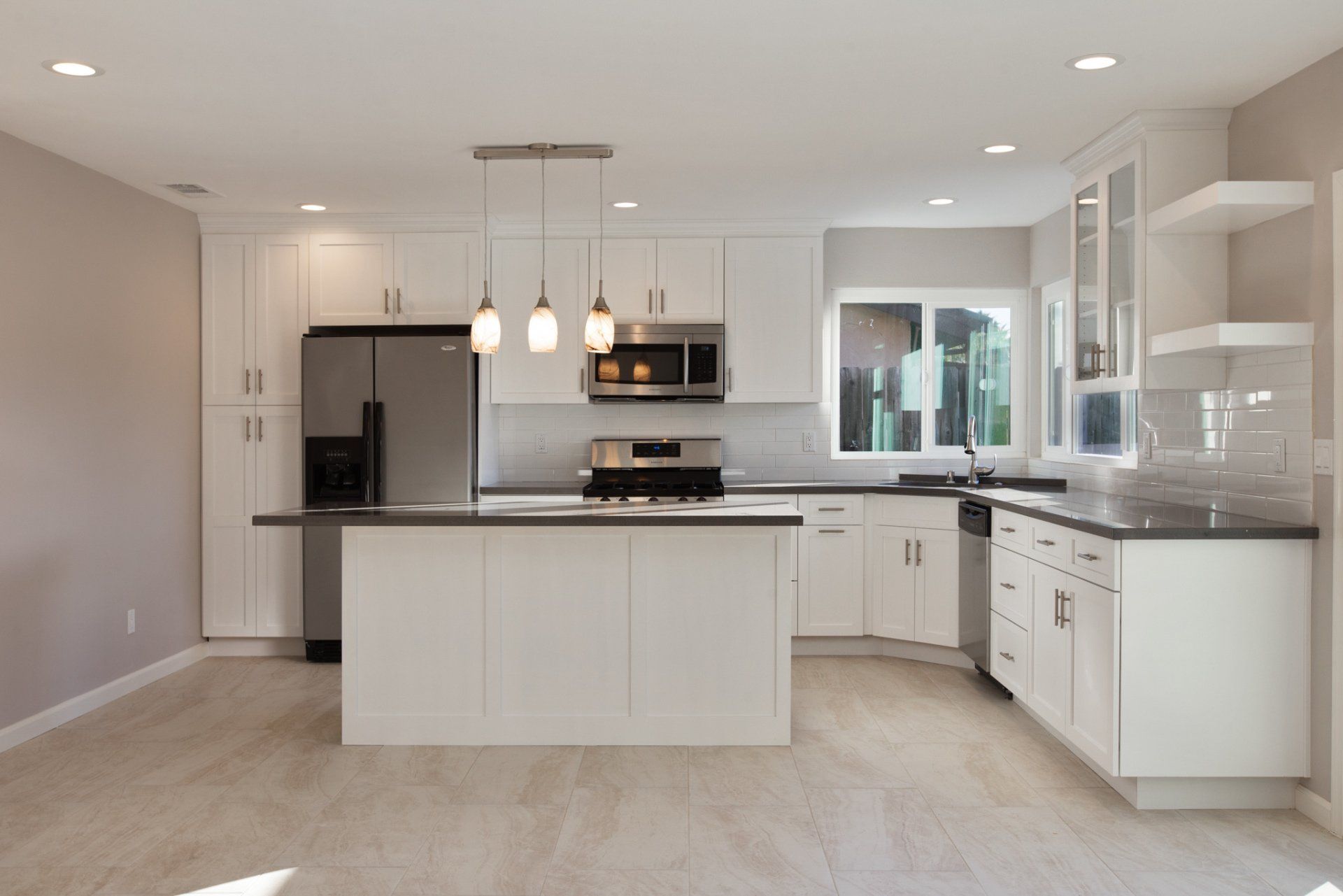 A kitchen with white cabinets and stainless steel appliances