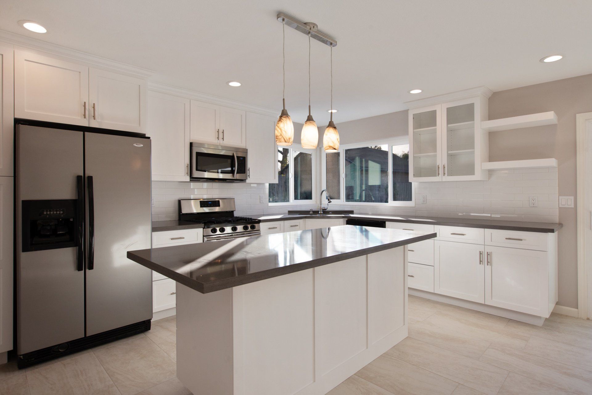 A kitchen with stainless steel appliances and white cabinets