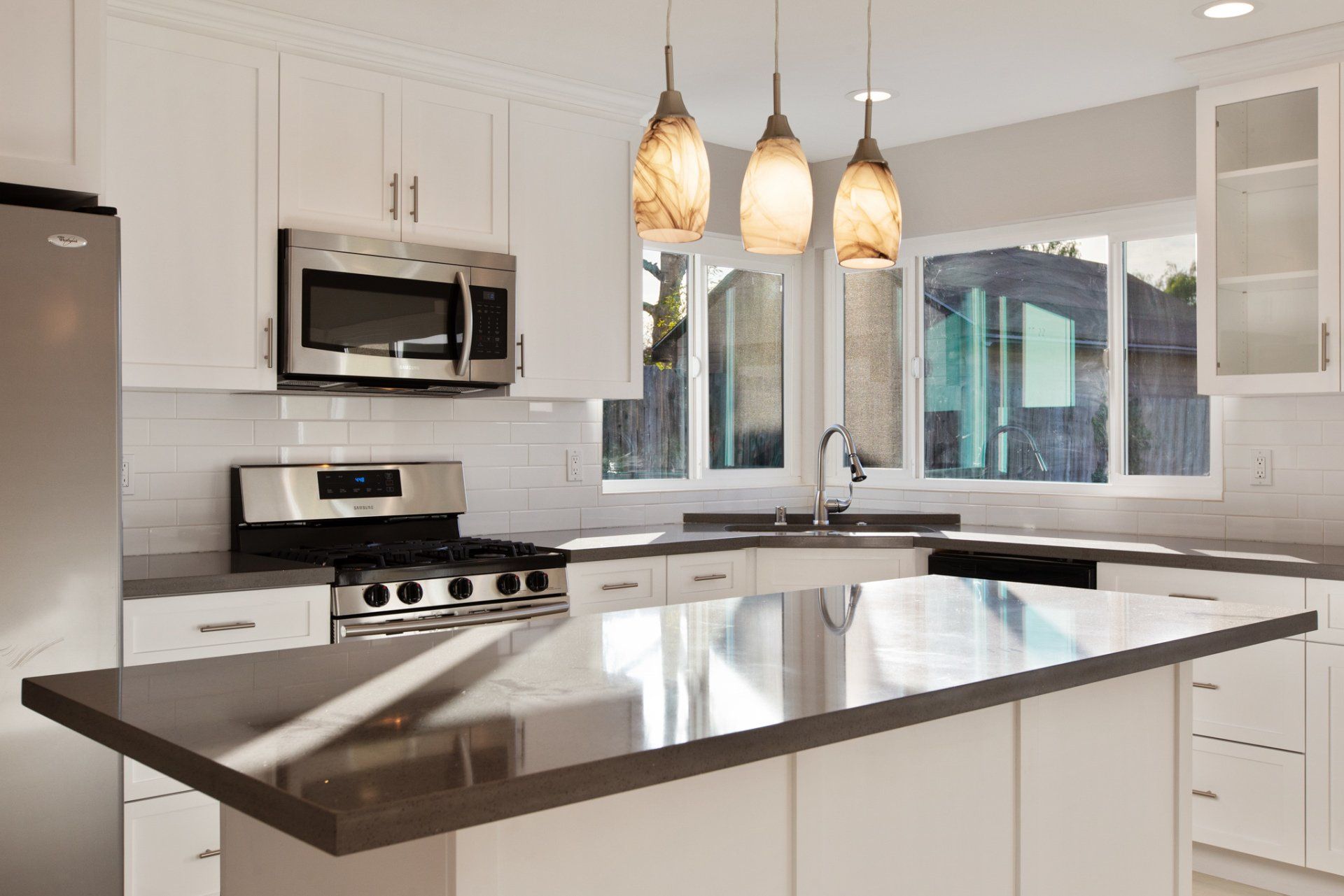 A kitchen with stainless steel appliances and white cabinets