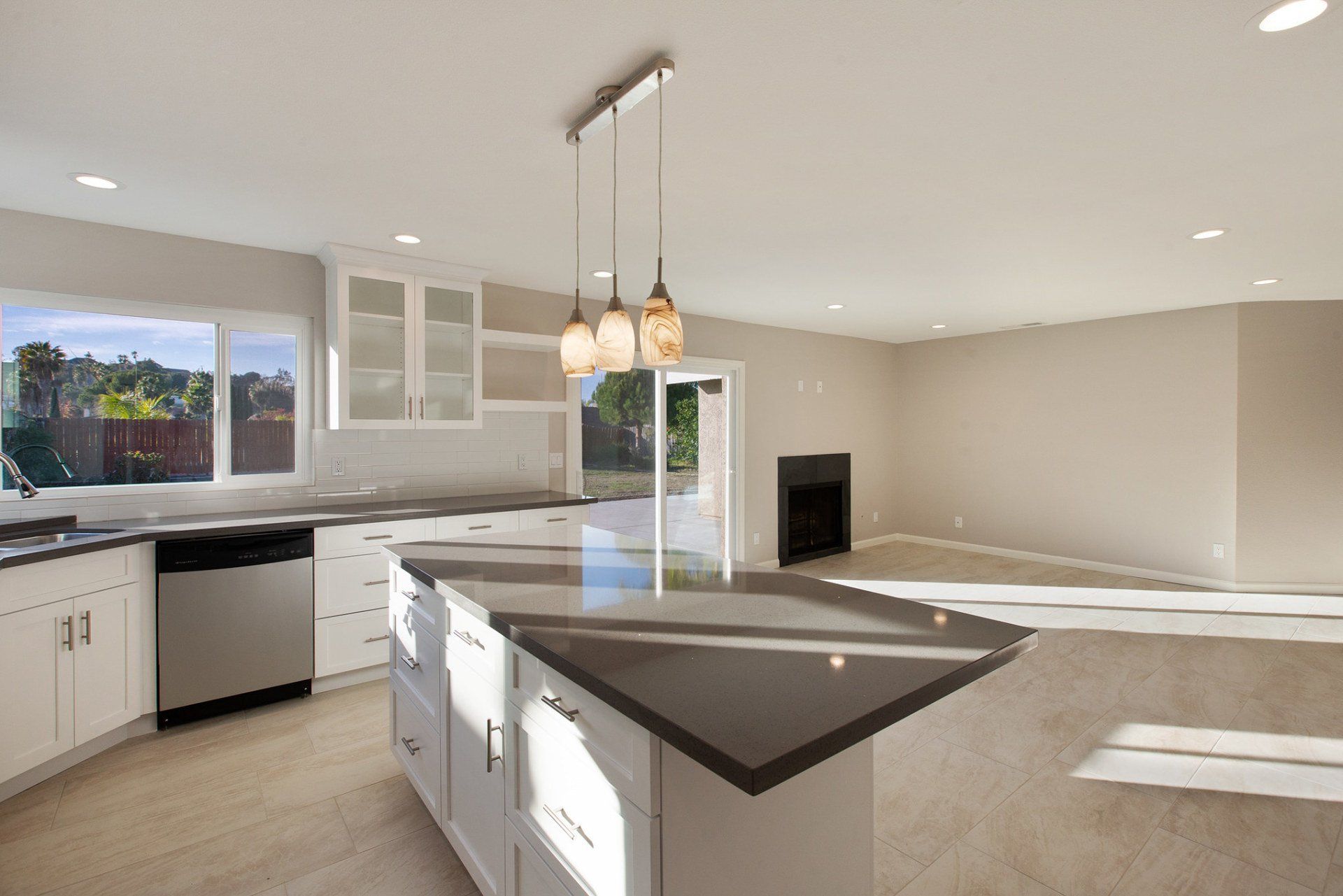 An empty kitchen with a large island in the middle