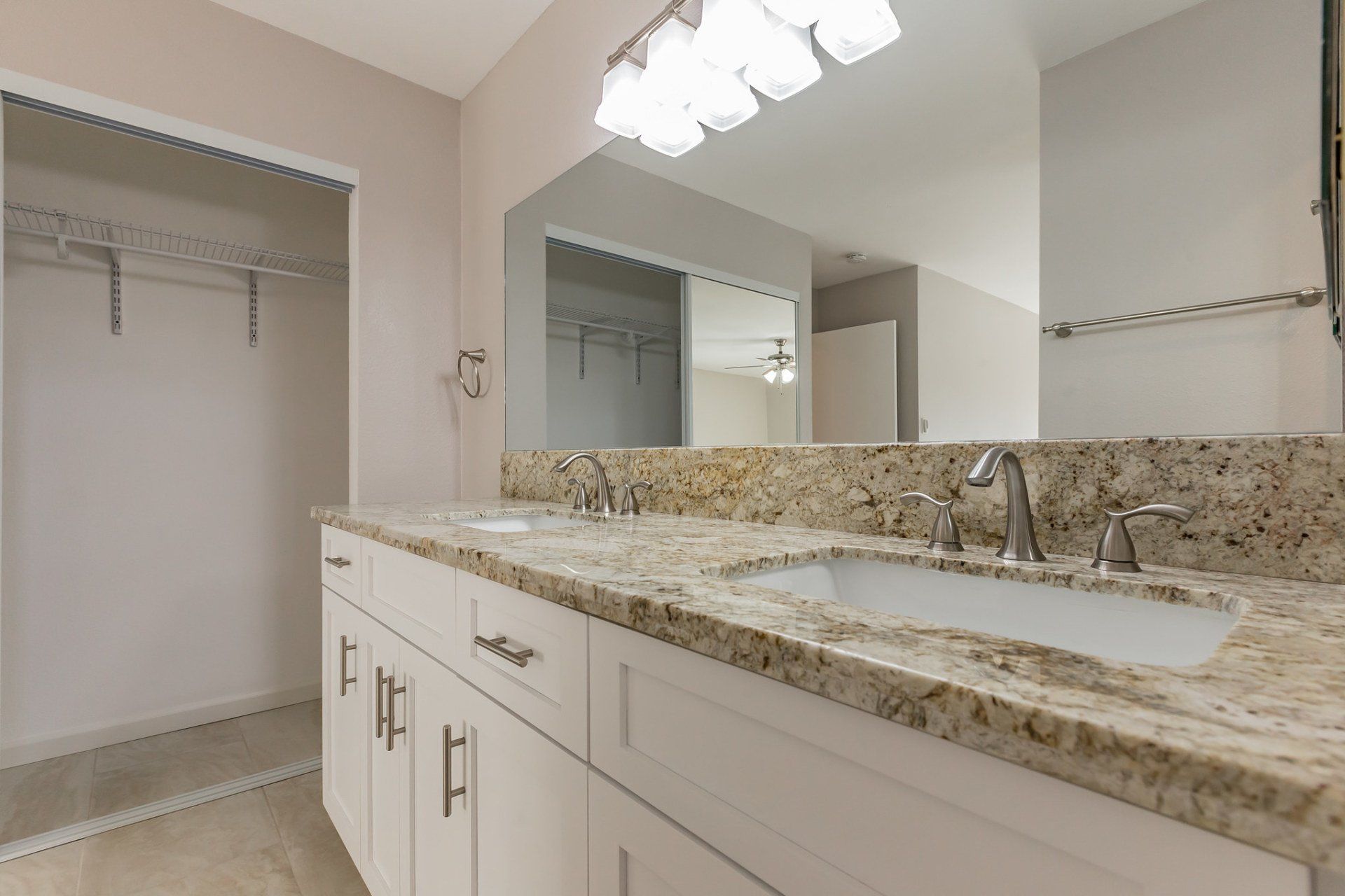 A bathroom with two sinks and a large mirror