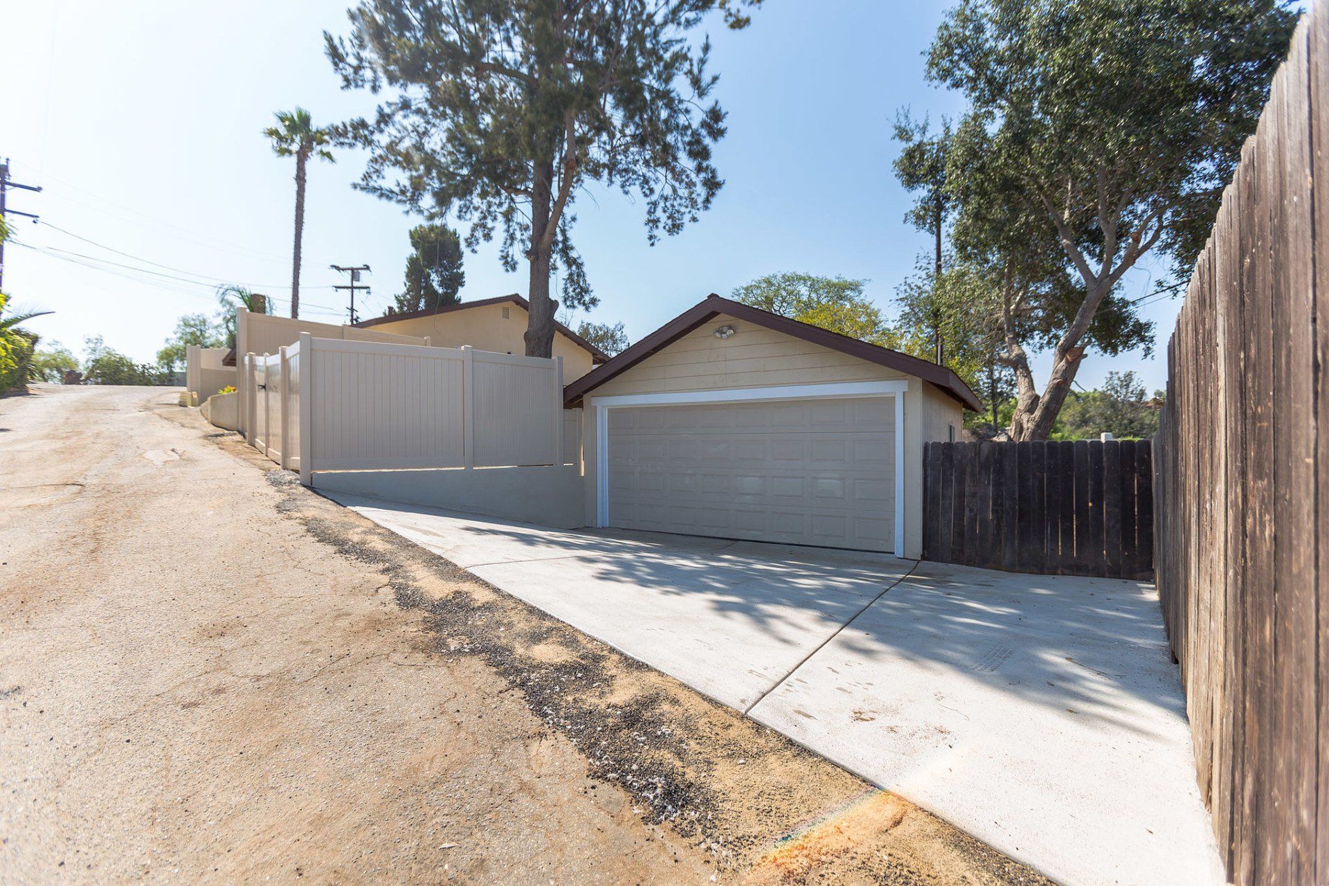 A house with a garage and a wooden fence