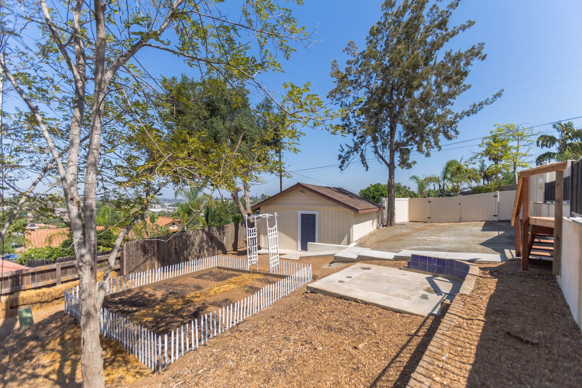 The backyard of a house with a fence and stairs