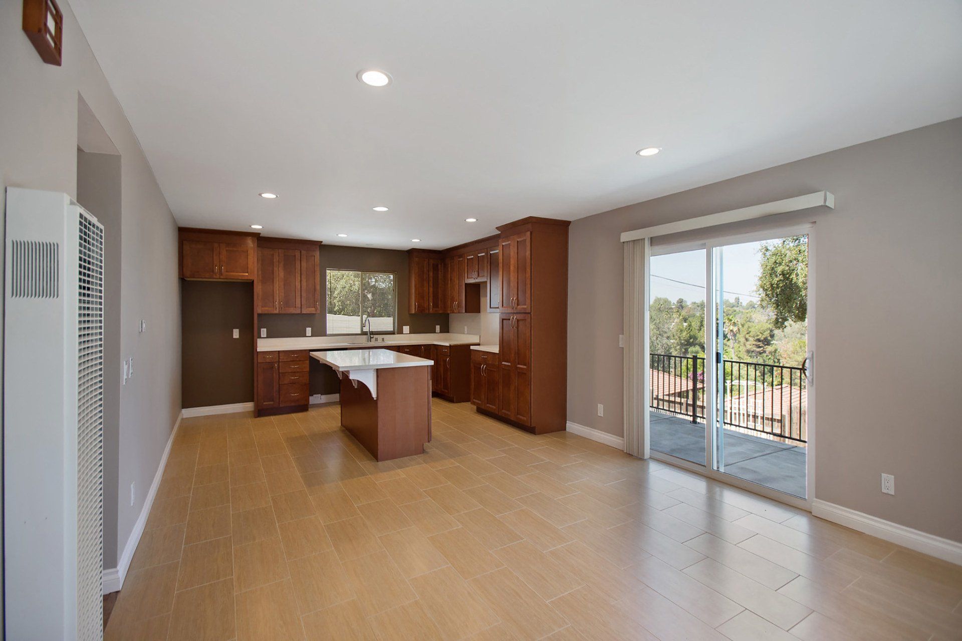 An empty kitchen with a sliding glass door