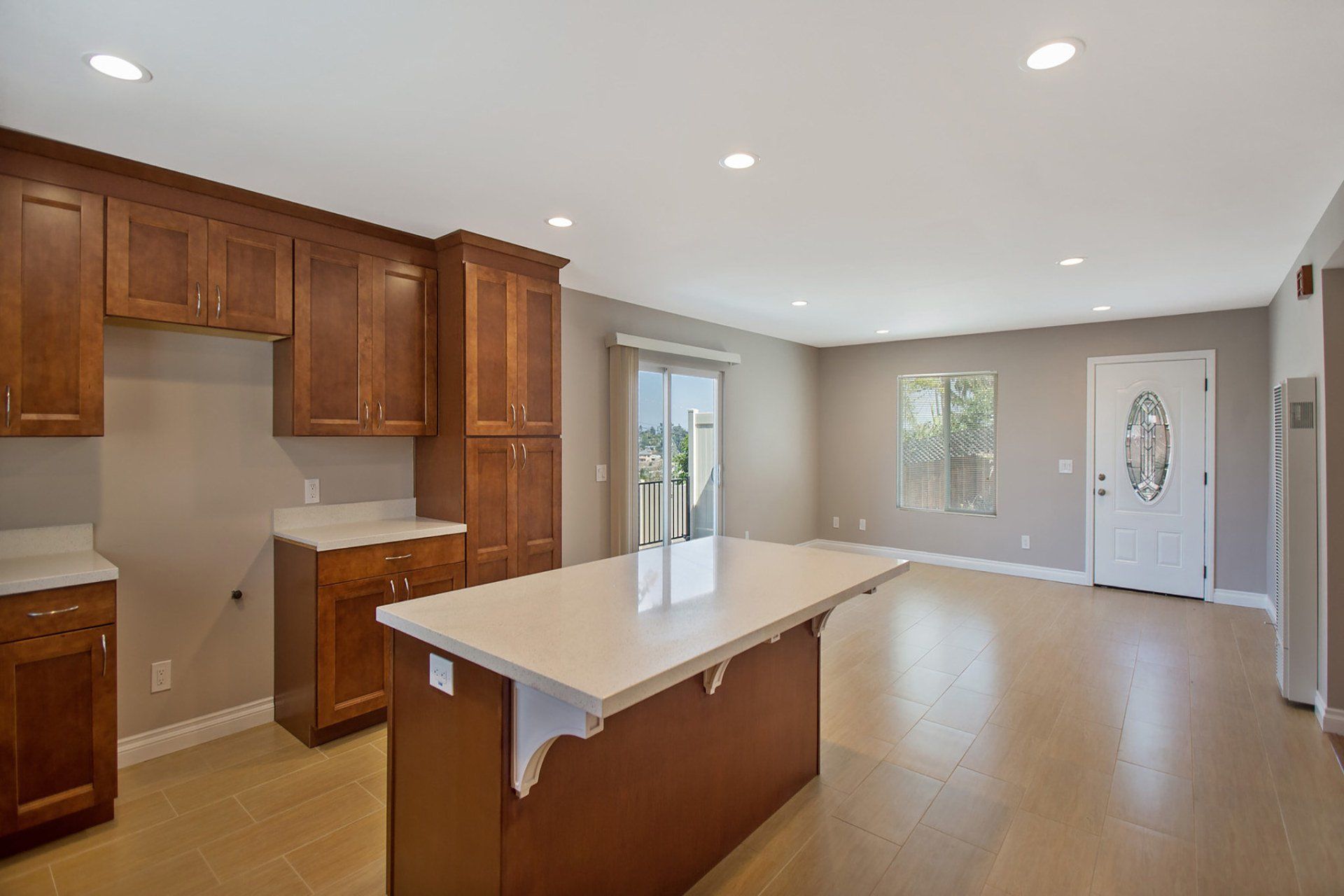 An empty kitchen with a large island in the middle