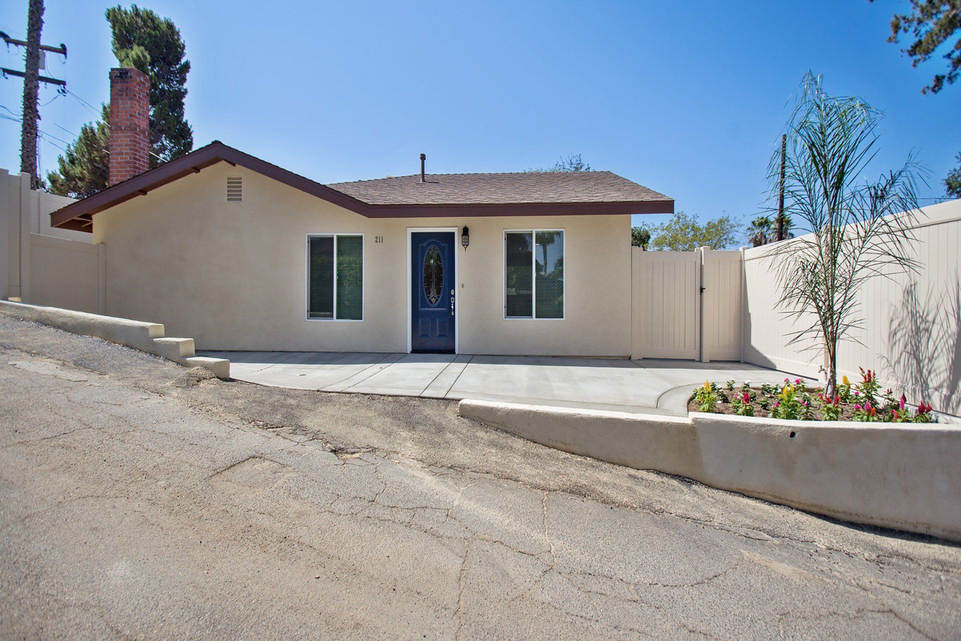 A white house with a blue door and windows