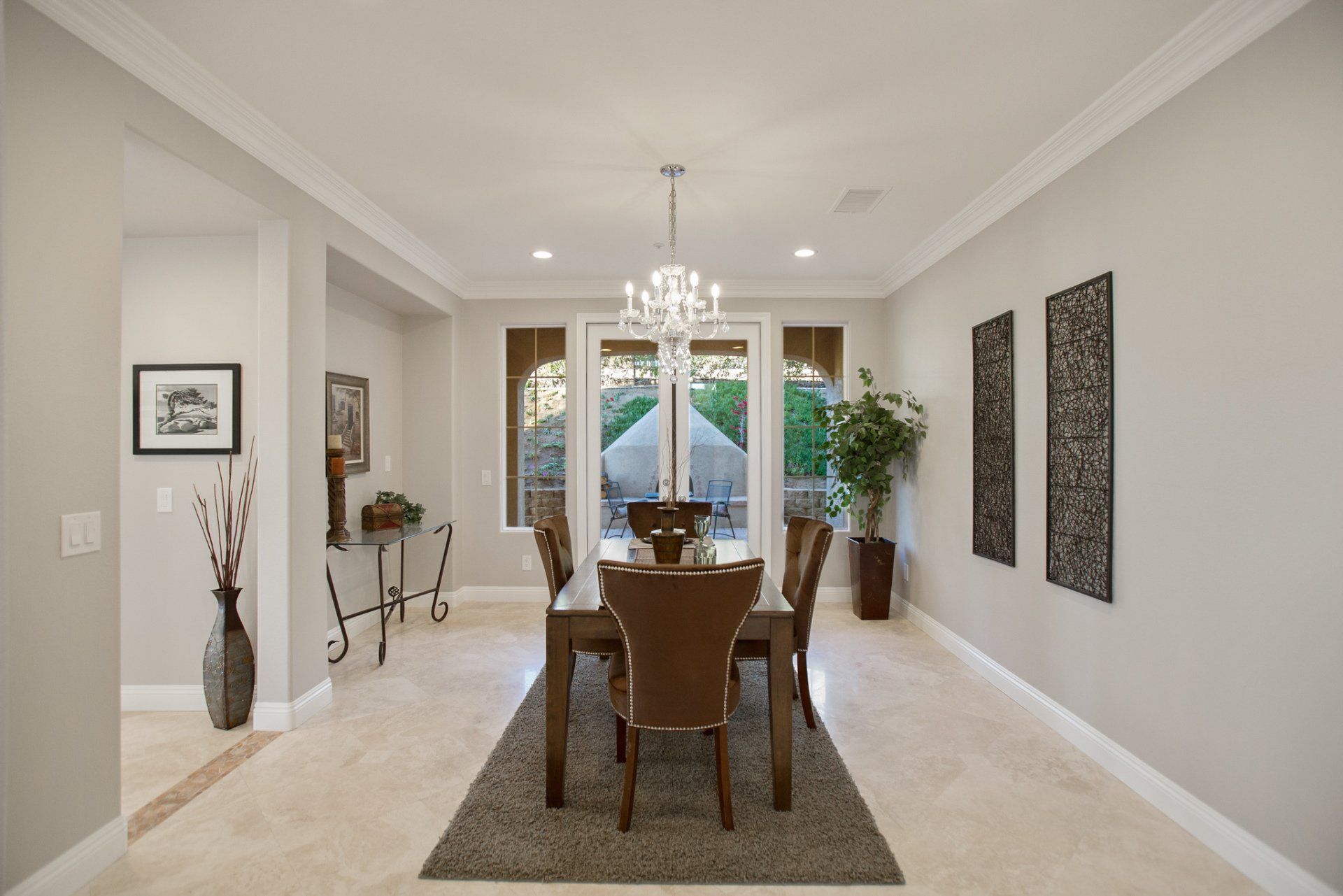 A dining room with a table and chairs and a chandelier