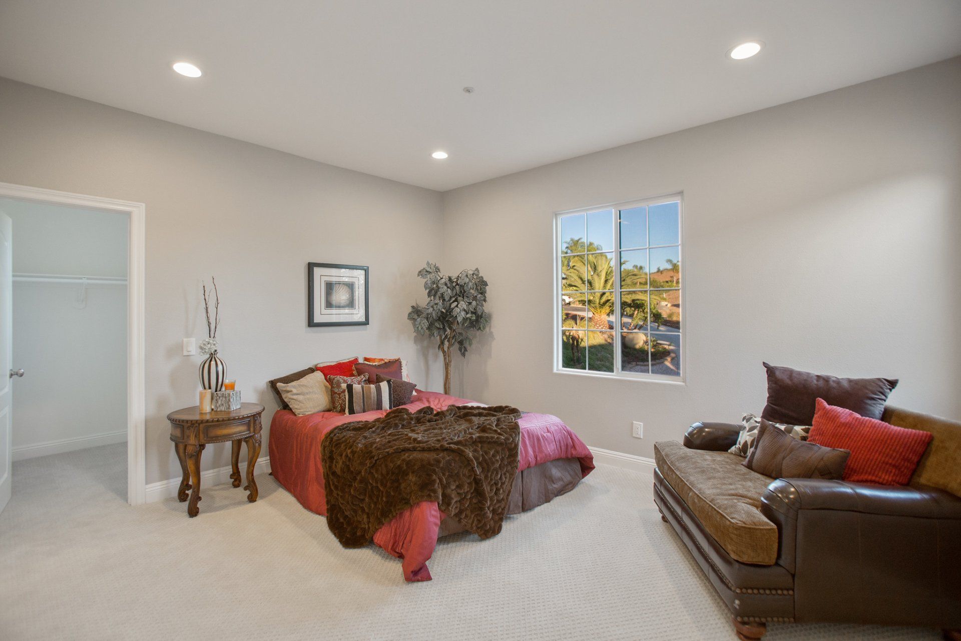 A bedroom with a bed , couch , and window.