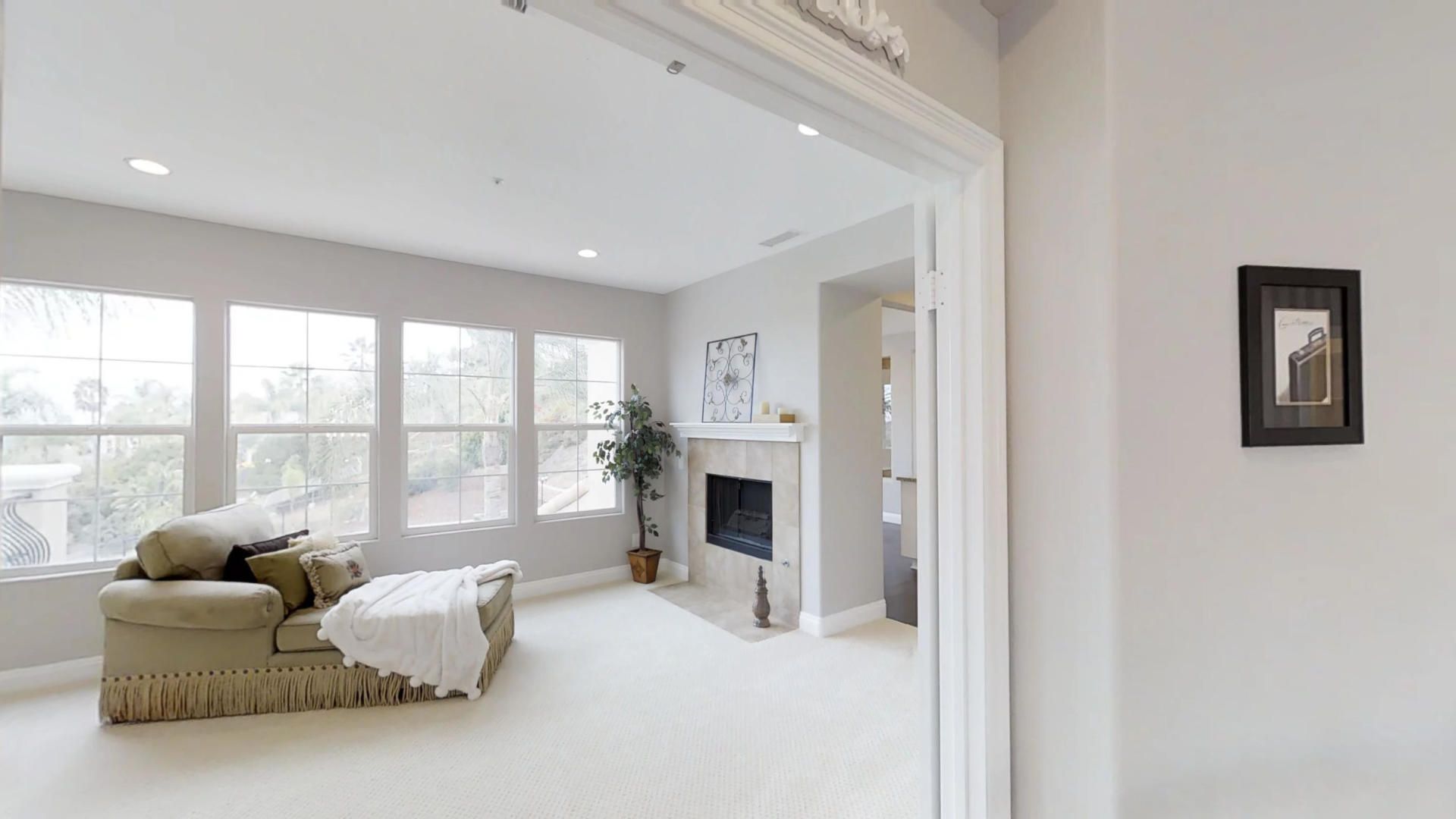 A living room with a fireplace and a lot of windows