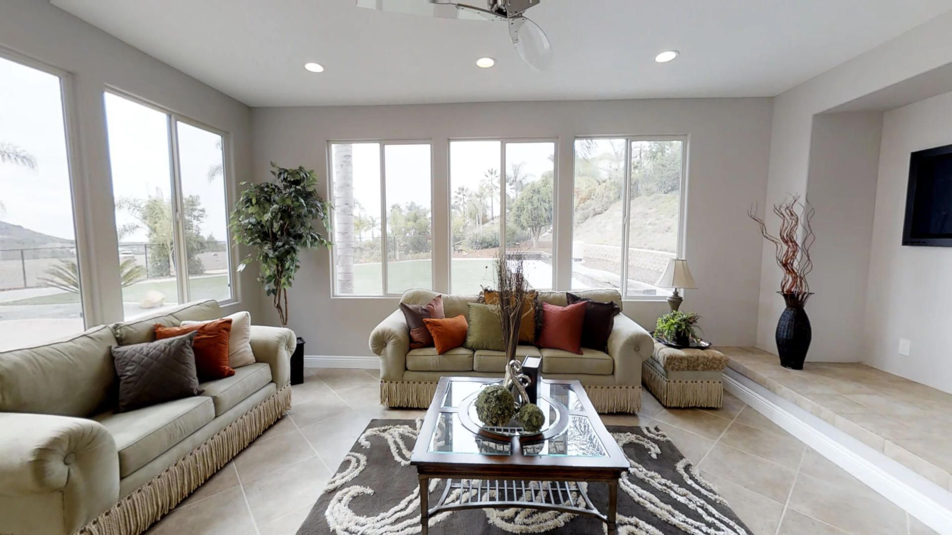 A living room with two couches , a coffee table , and a television.