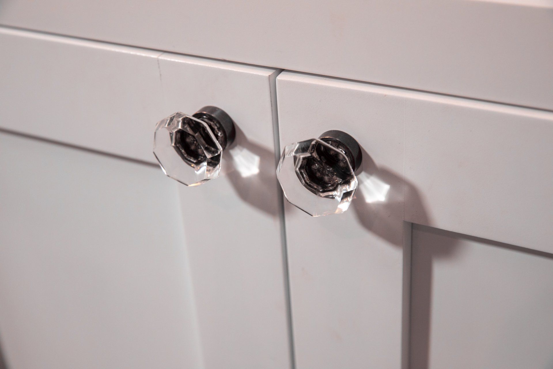 A close up of a cabinet with clear knobs