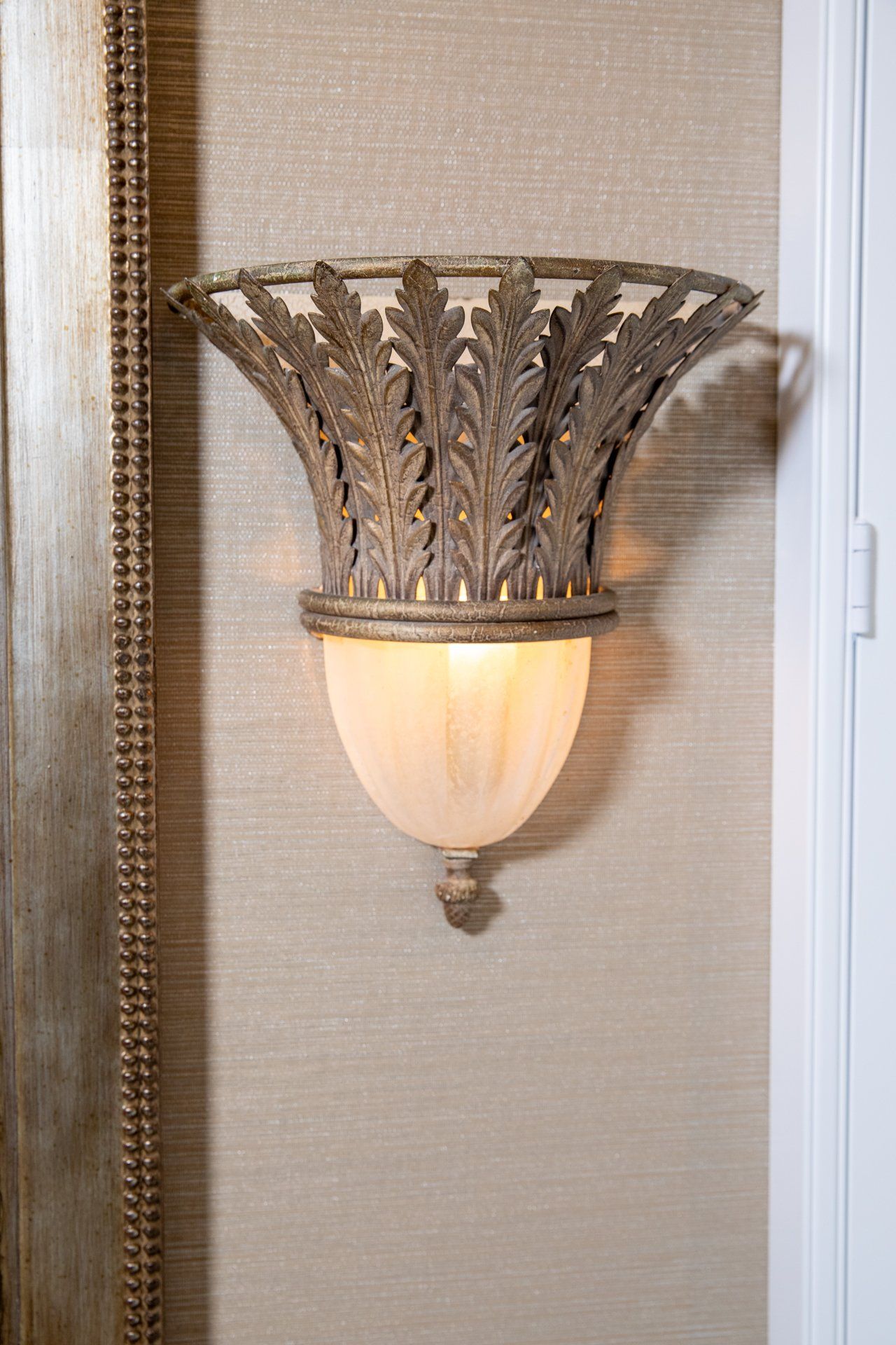 A wall light with a leaf design on it