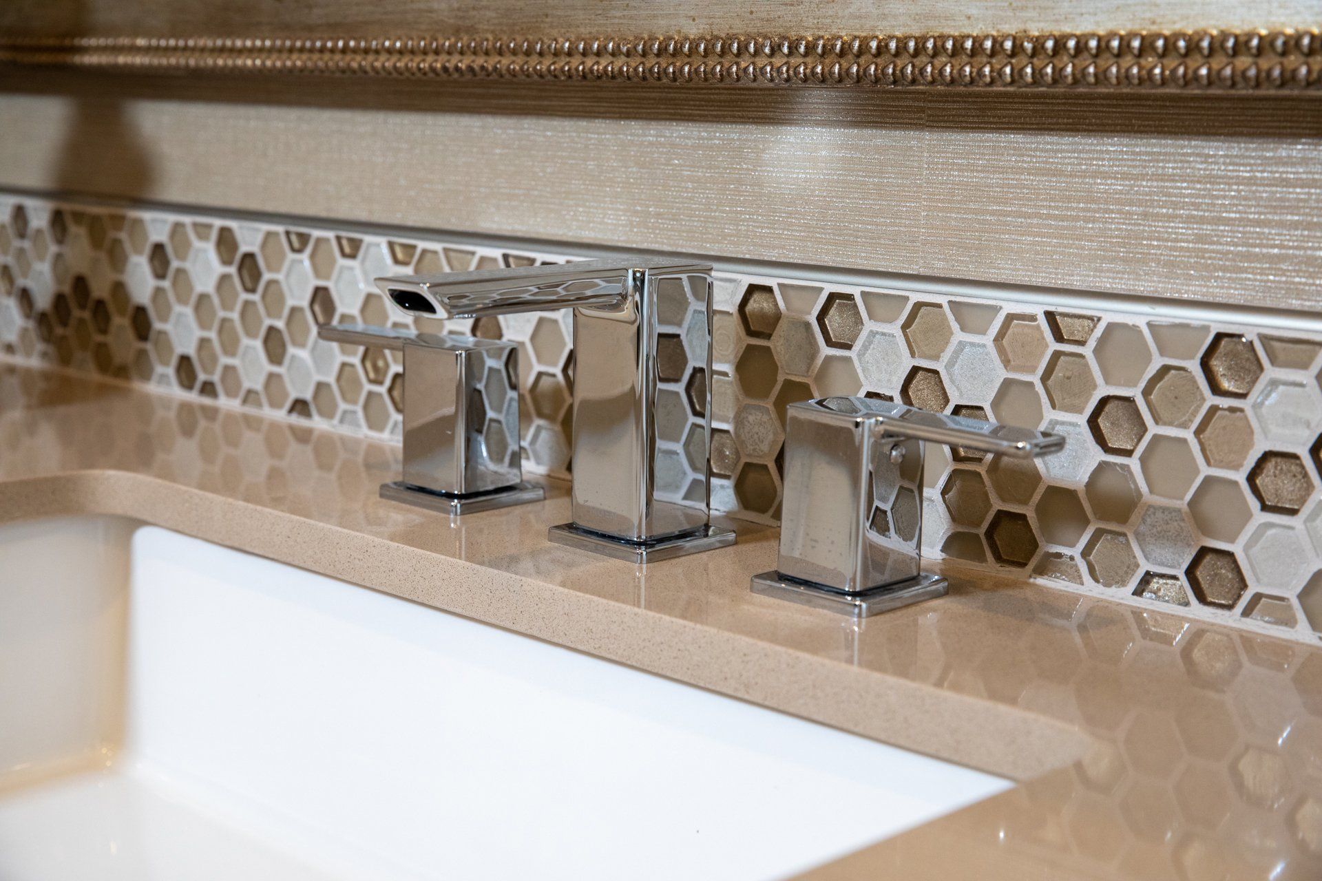 A bathroom sink with a honeycomb tile border