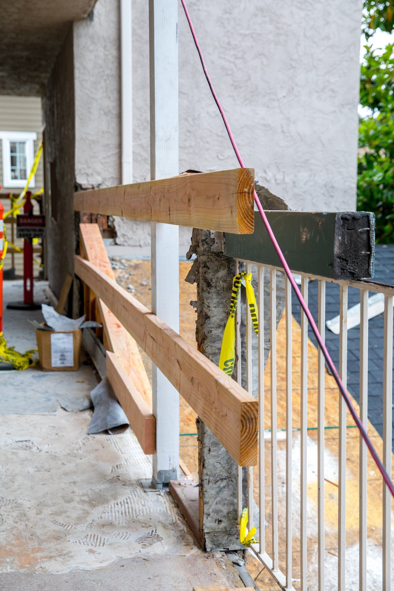 A wooden railing is being built on a balcony