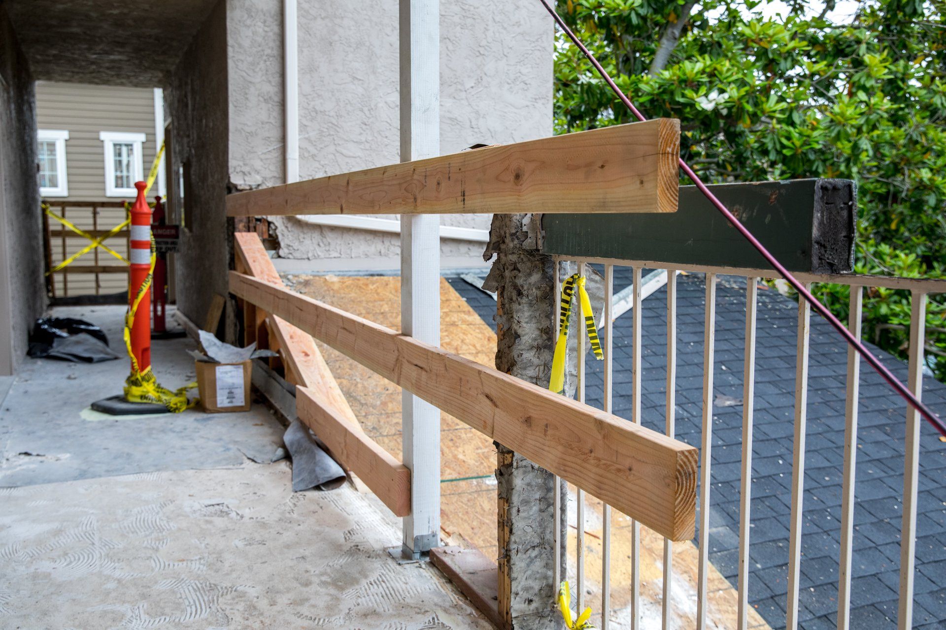 A wooden railing is being built on the side of a building