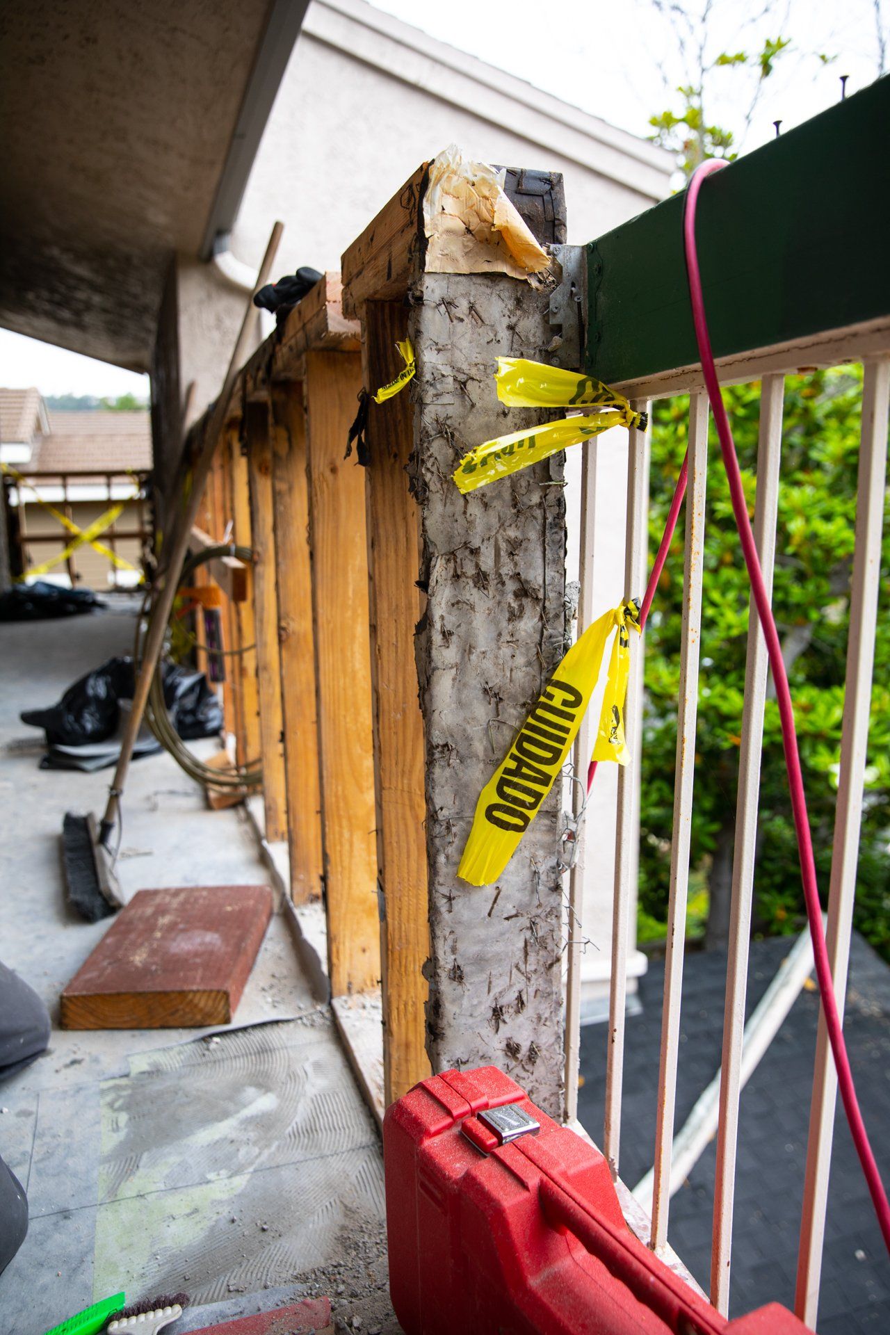 A yellow caution tape is hanging from a railing