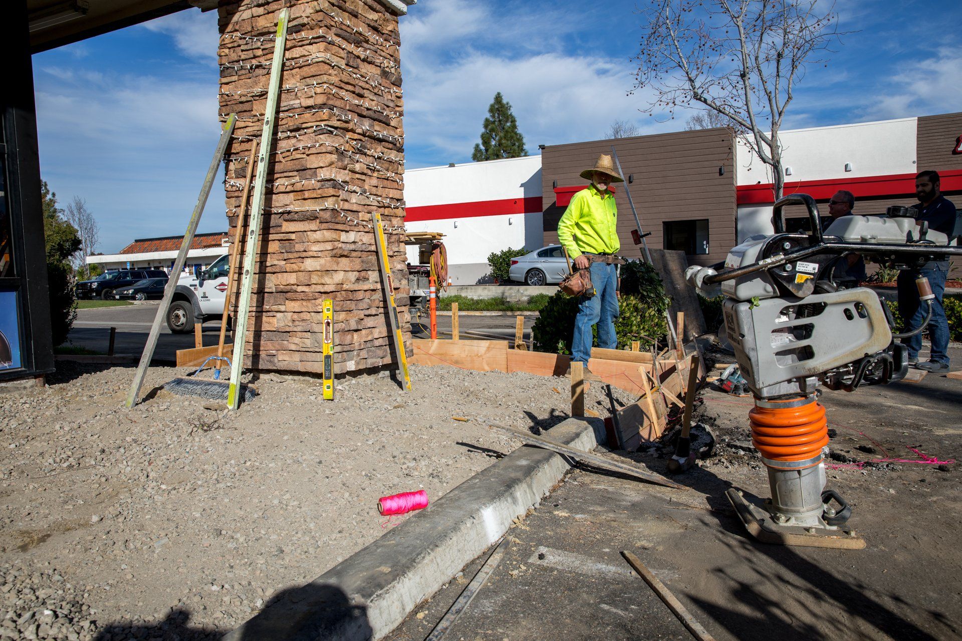 A man in a yellow shirt is working on a construction site