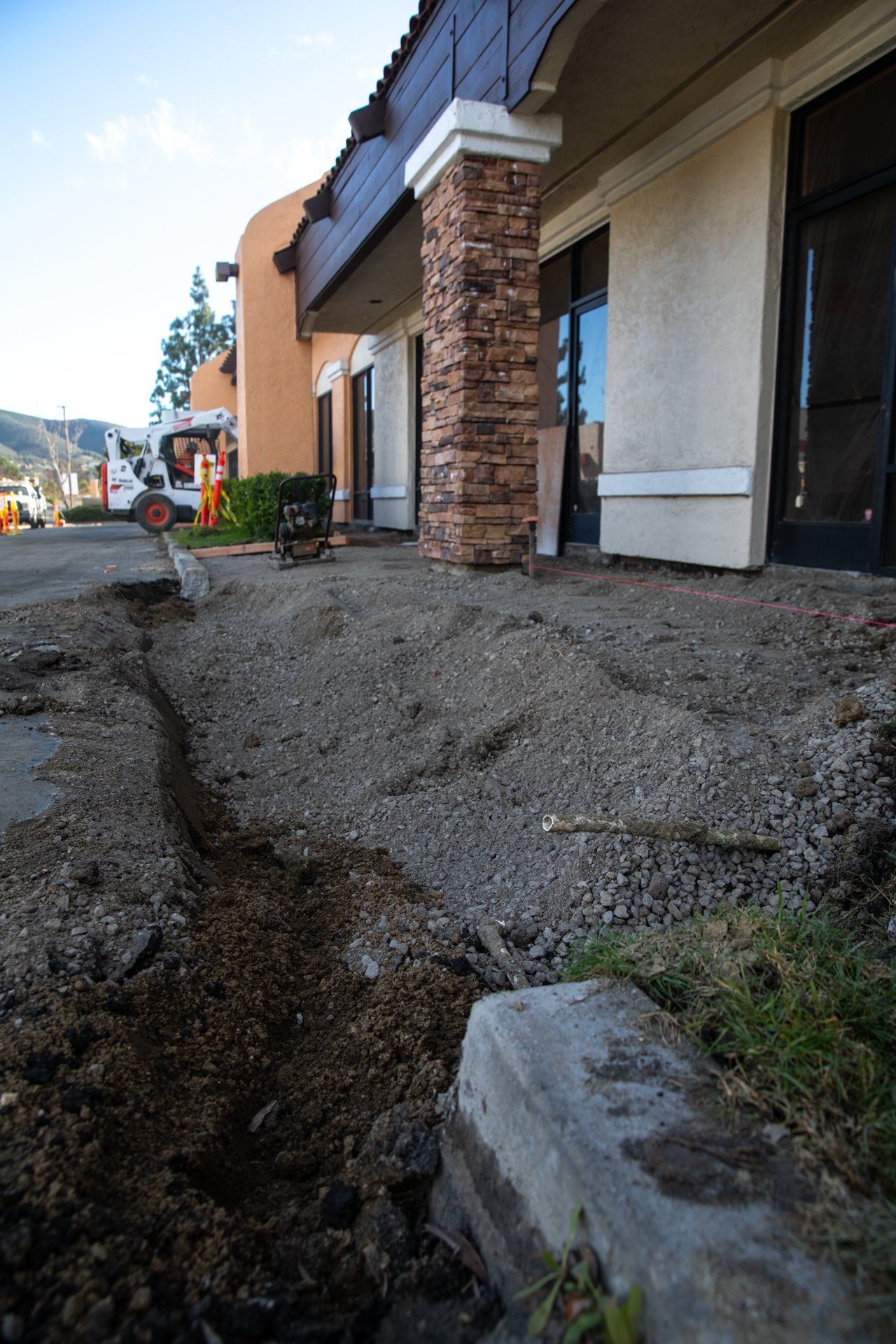 A concrete walkway is being built in front of a building