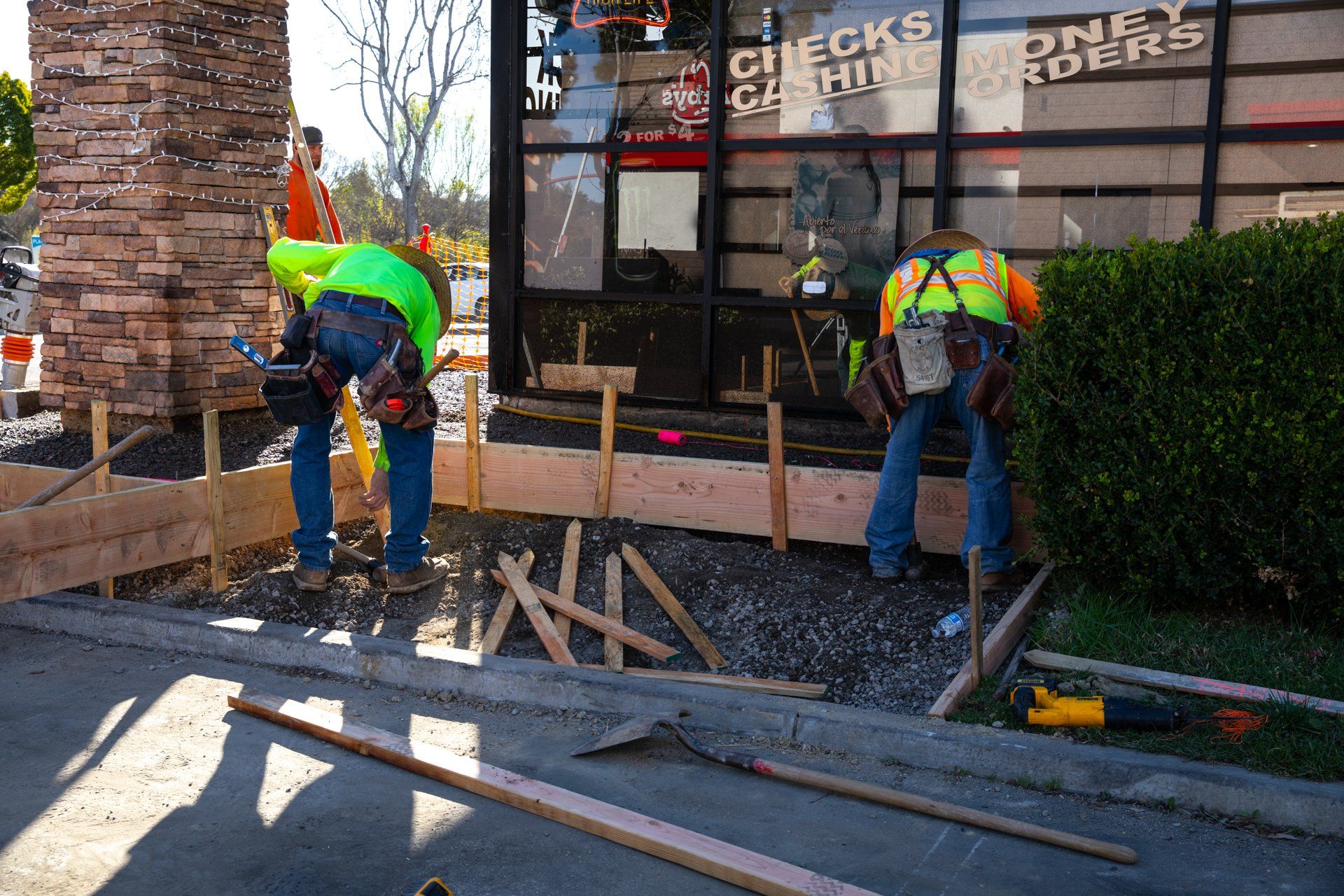 Construction workers are working in front of a building that says ' checks ' on it