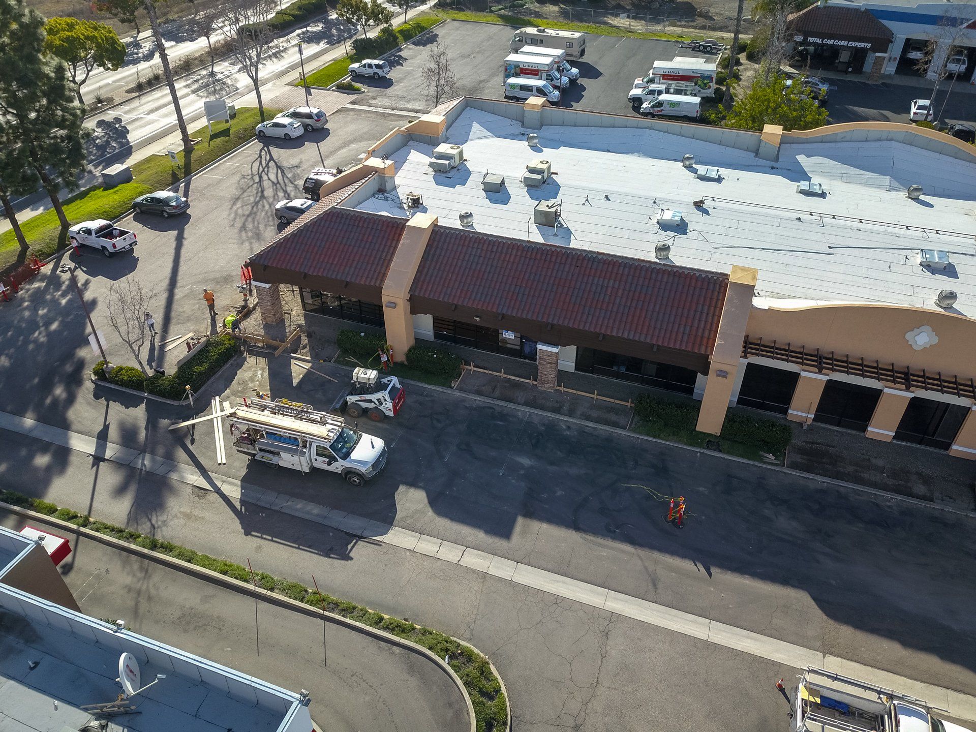An aerial view of a building with a white roof