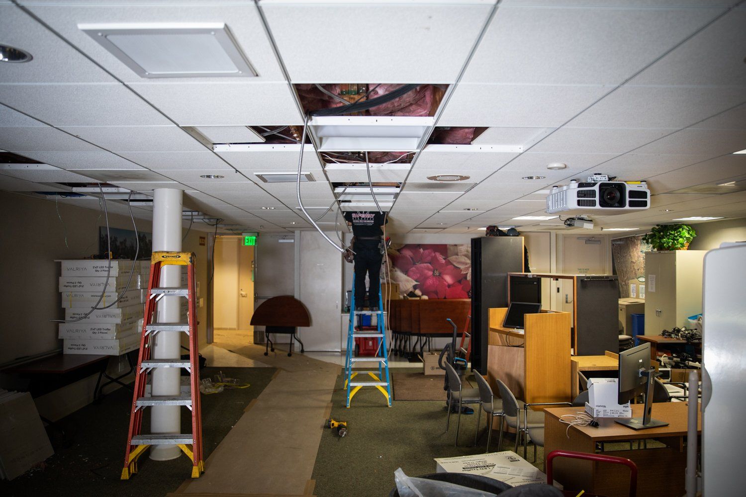 An empty office with a ladder in the middle of the room