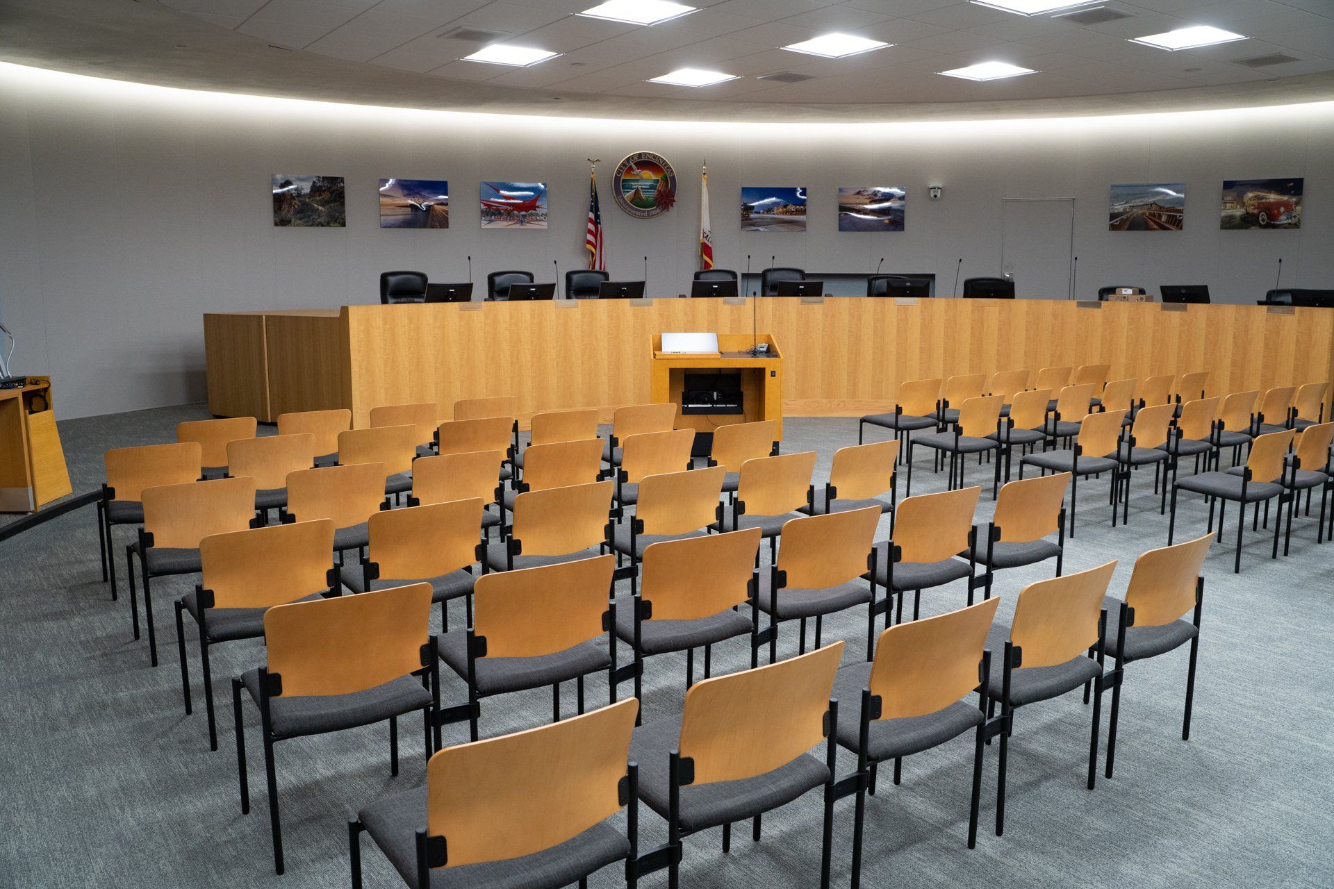 Rows of chairs in a room with a podium in the middle