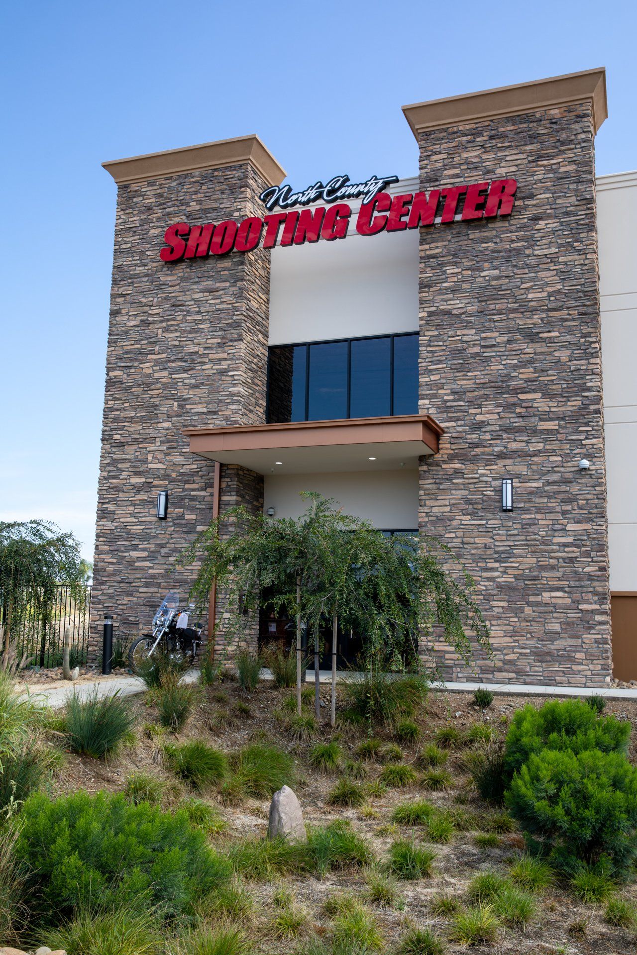 A large brick building with a red sign on the side of it.