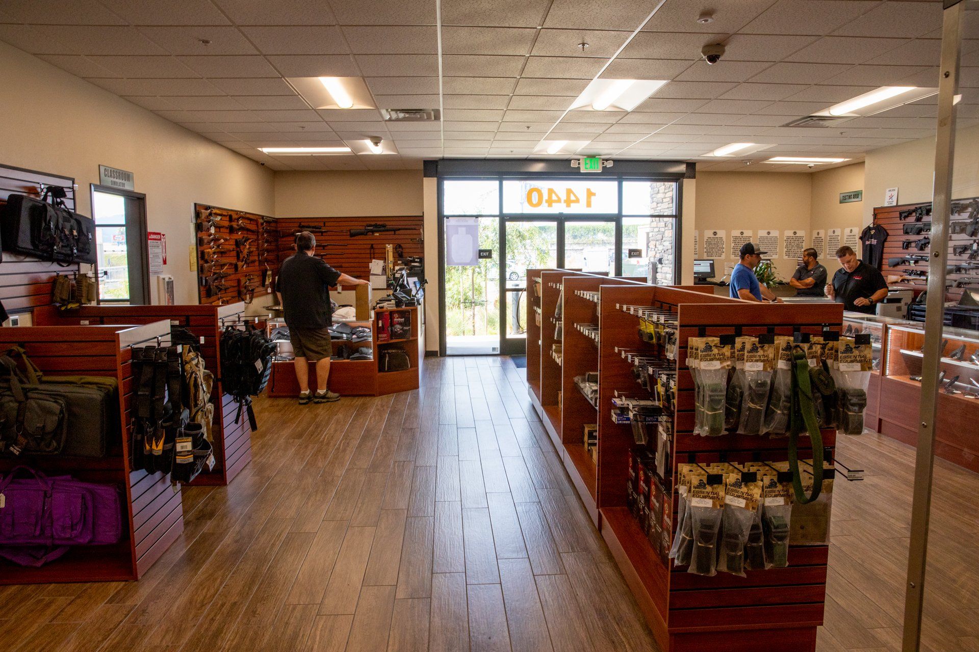 A man is standing in front of a counter in a store.