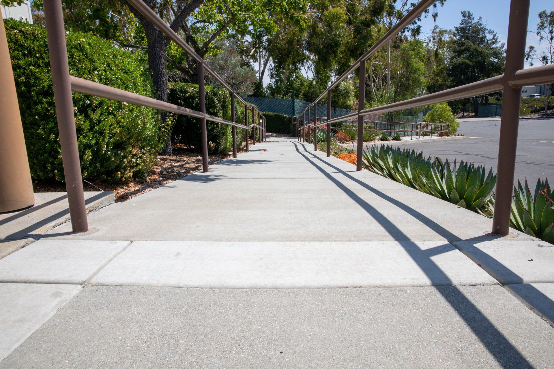 A set of stairs leading up to a parking lot