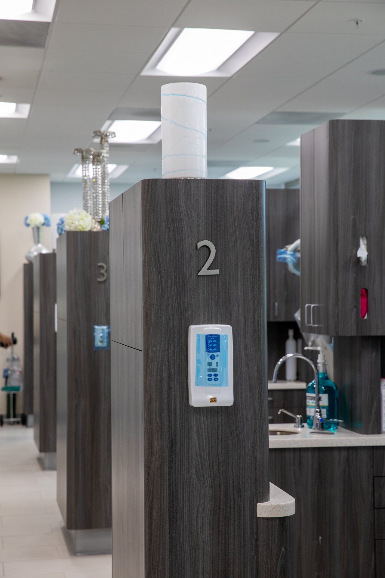 A row of dental chairs with numbers on them in a dental office.