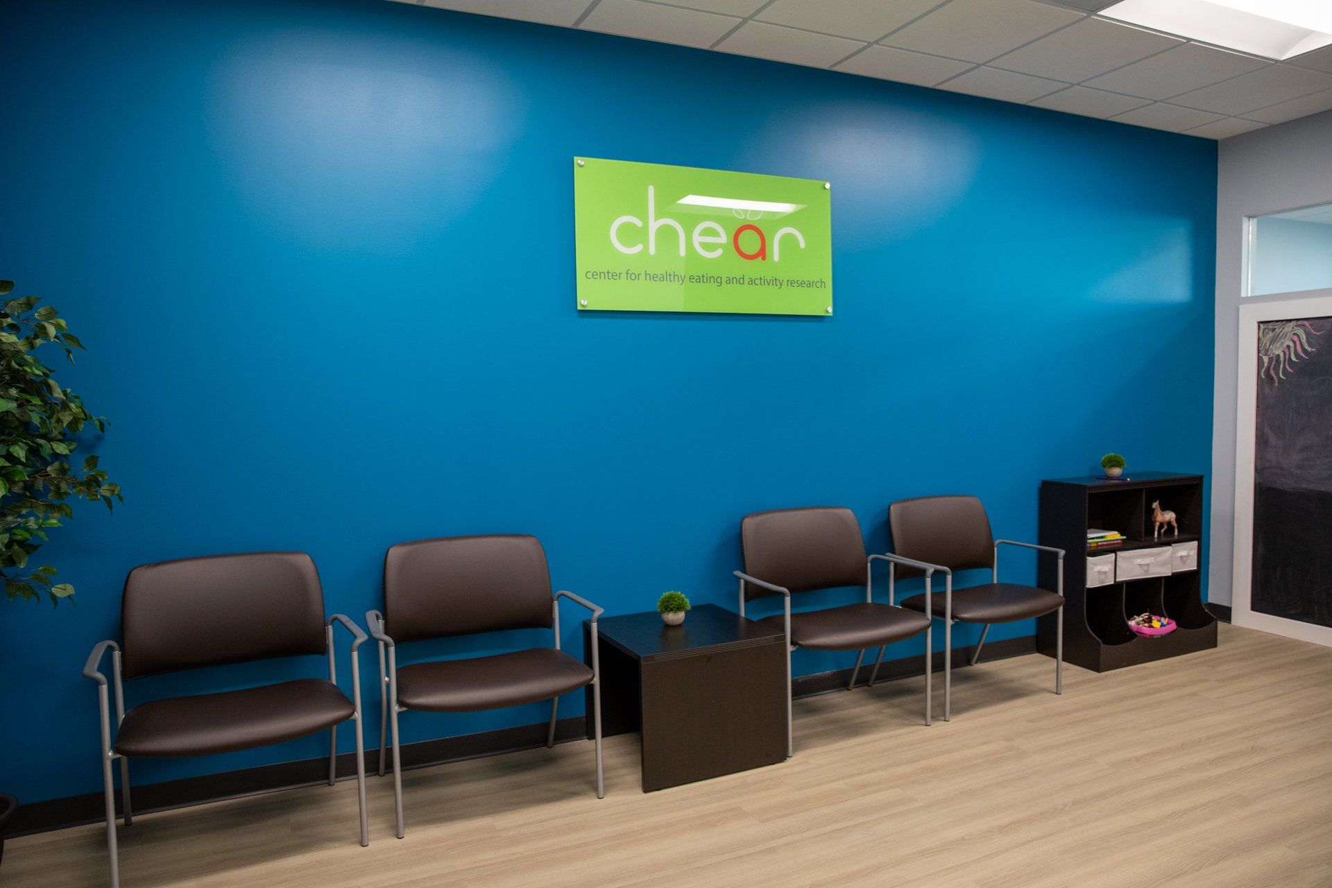 A waiting room with chairs and a sign that says cheer
