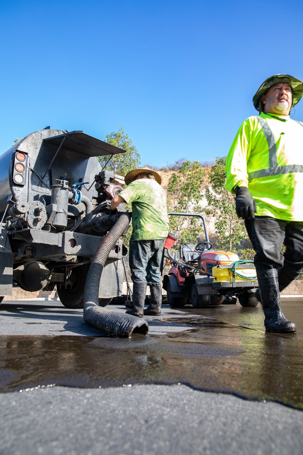 A couple of men are standing next to a truck.