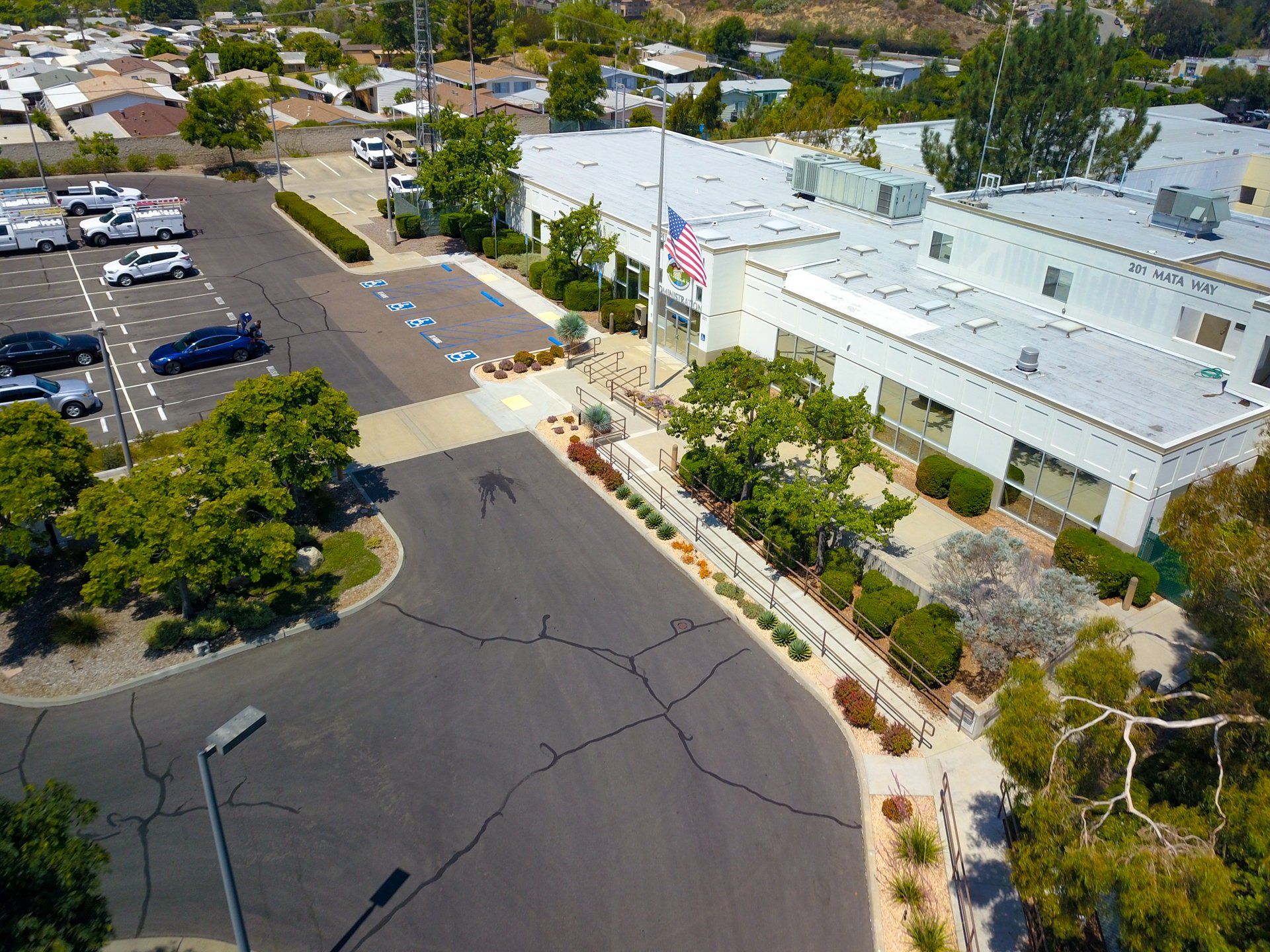 An aerial view of a building with a parking lot in front of it