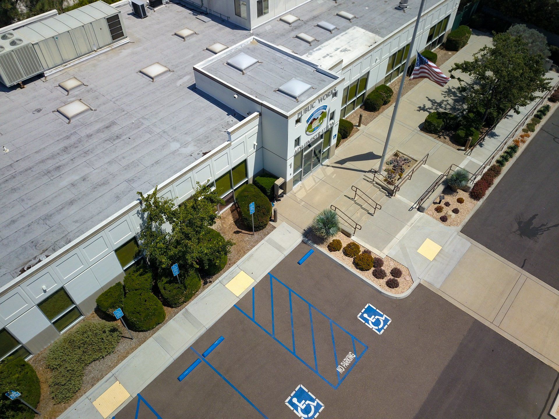 An aerial view of a building with a handicapped parking spot in front of it