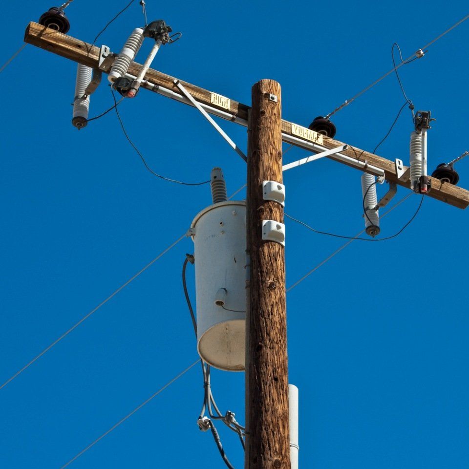 Wooden pole with overhead power line