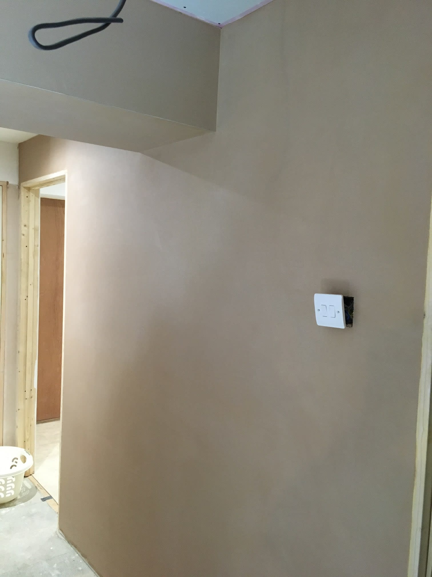 Freshly plastered wall with light switch