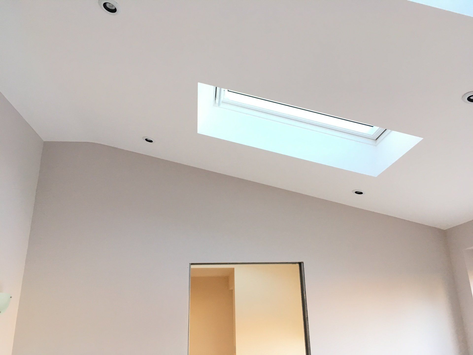Freshly plastered white ceiling around skylight