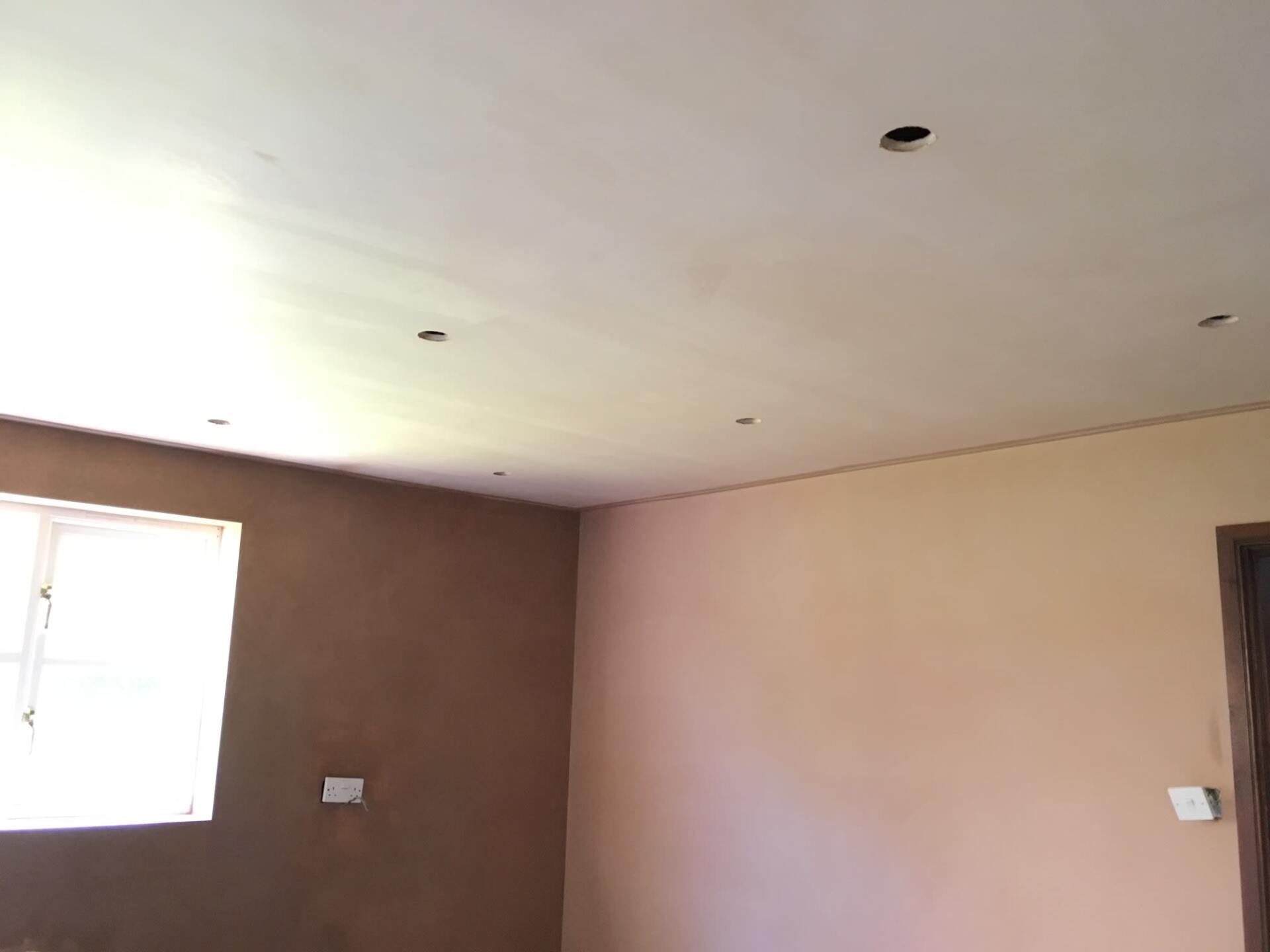 A freshly plastered room with light fightings