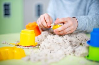 Child Playing at Sand Table
