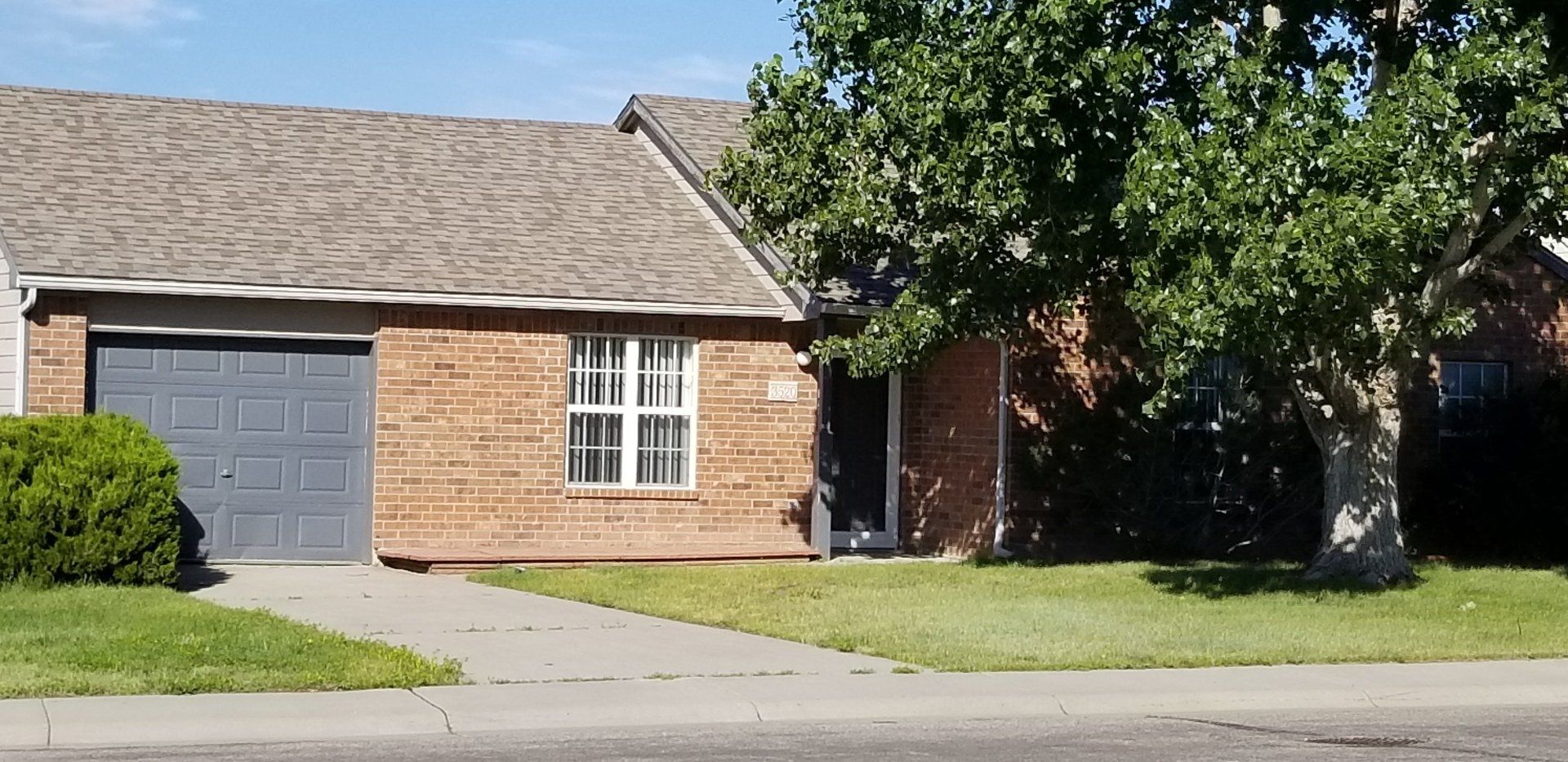 Exterior of apartment home with grass out front