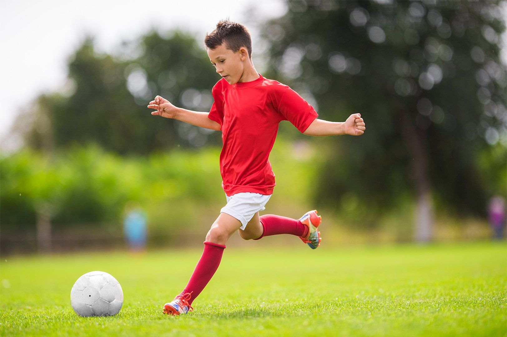 Little Boy Shooting at Goal