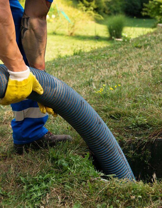 A man is pumping a hose into a hole in the ground-The Trailer Factory In Port Macquarie, NSW