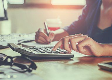 Professional Accountants — Woman Using Calculator in Semmes, AL