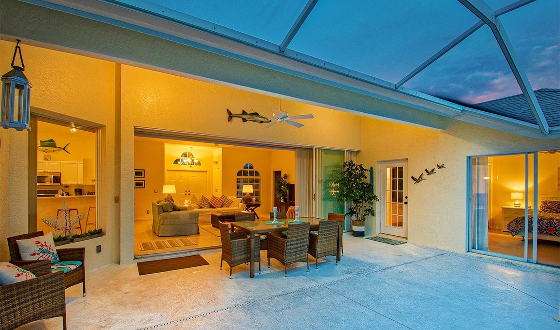 Lanai with outdoor dining area at sunset at Naples Lake View, Briarwood, Florida
