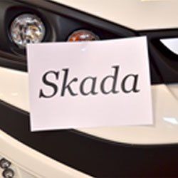 Close-up of a car with a white paper note reading