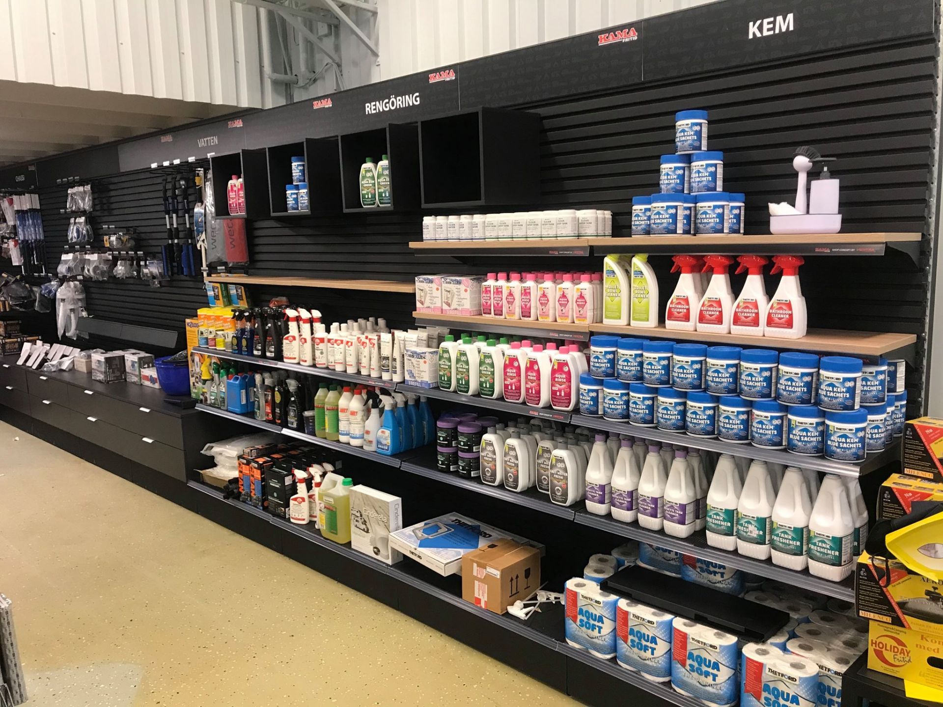 Shelves in a store filled with cleaning supplies, including bottles of cleaner, bleach, and other products.