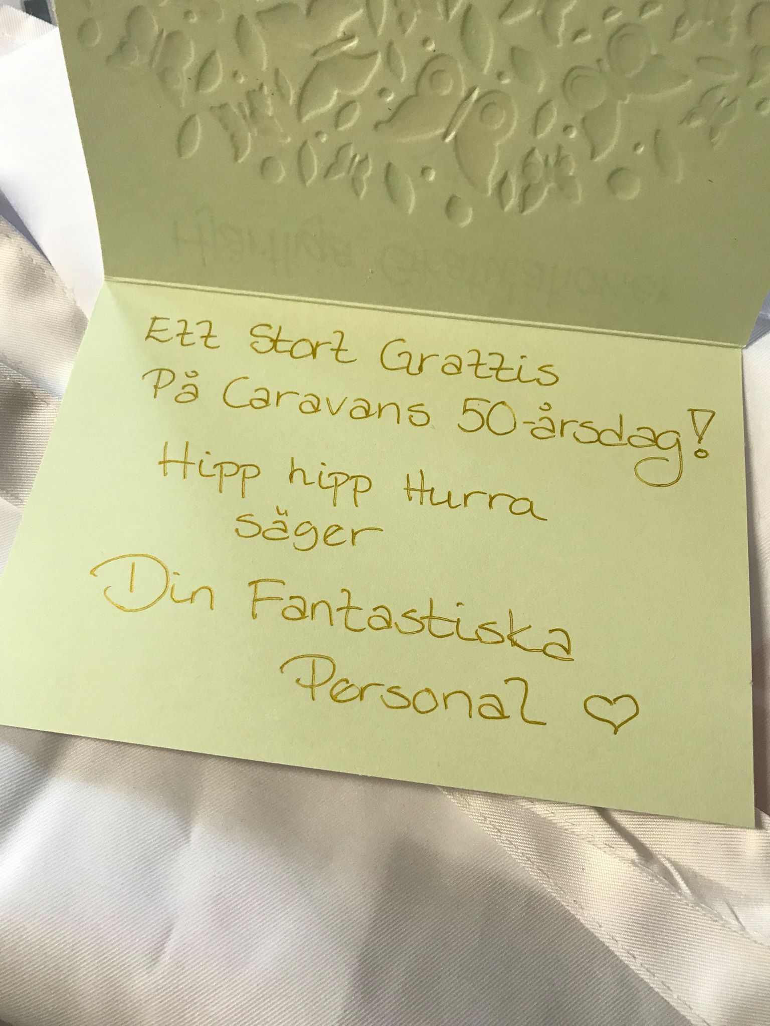 Green card with gold text wishing